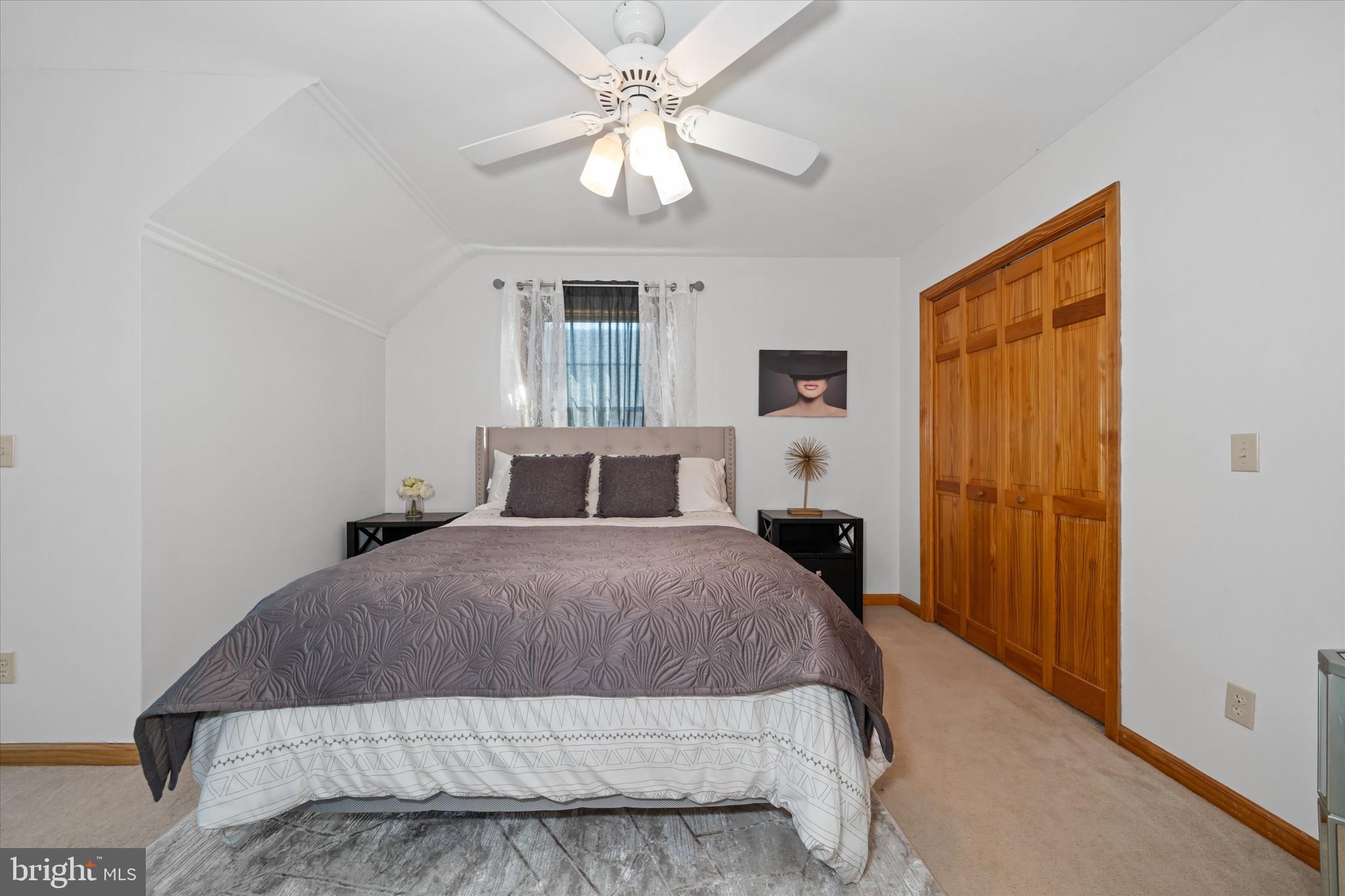 1265 Bowman Road Milford, DE 19963 - Photo 39 of 60 a bedroom with a large bed and a chandelier