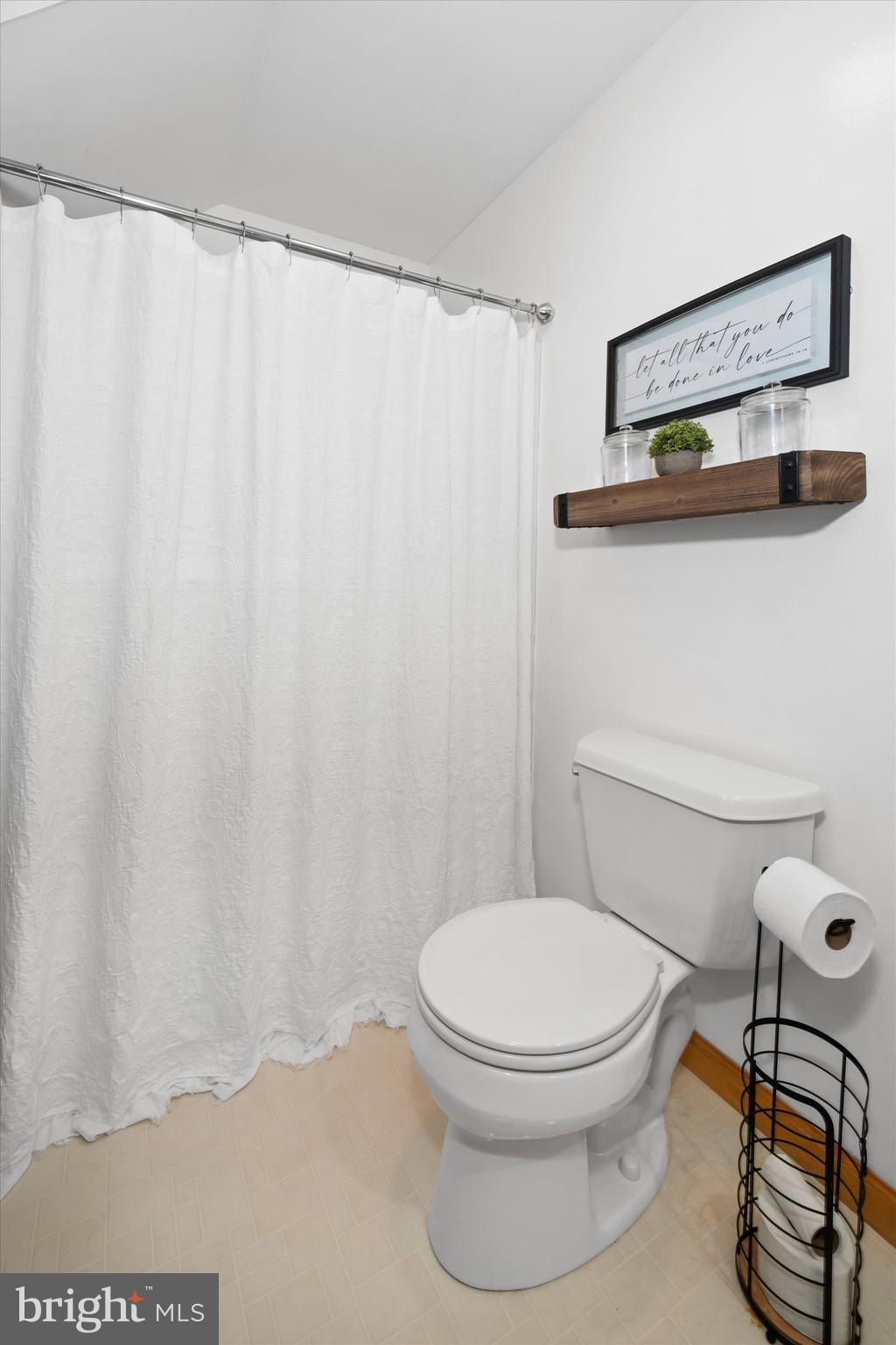 1265 Bowman Road Milford, DE 19963 - Photo 43 of 60 a white toilet sitting next to a shower curtain