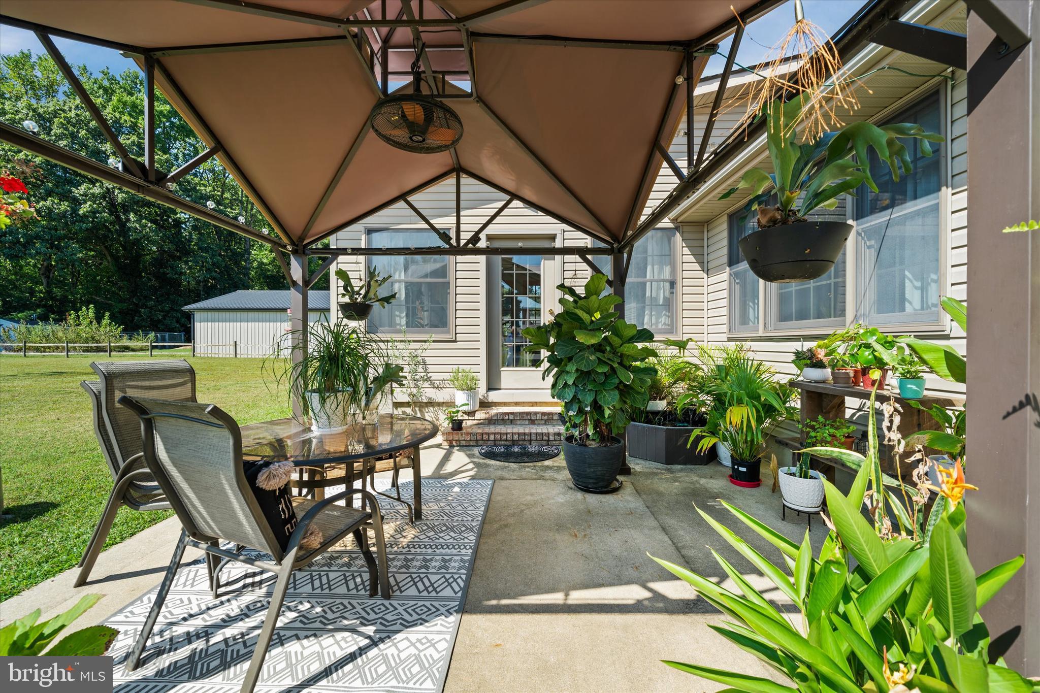 1265 Bowman Road Milford, DE 19963 - Photo 56 of 60 a view of a patio with table and chairs and potted plants