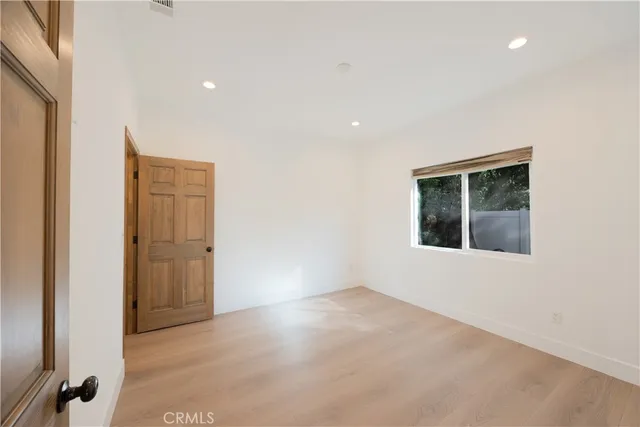 a view of a hallway with wooden floor and entryway