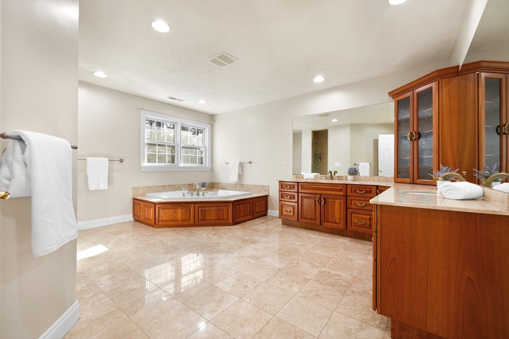 52 Chandler Circle Andover, MA 01810 - Photo 17 of 25 a spacious bathroom with a tub sink and mirror