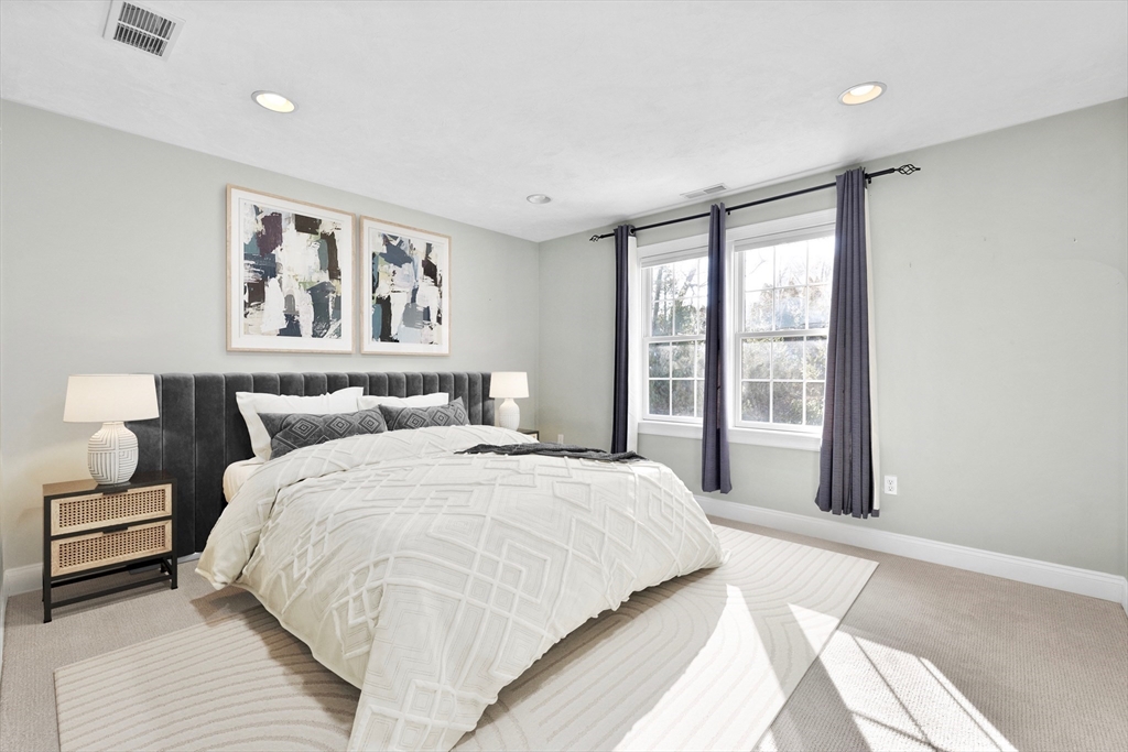 52 Chandler Circle Andover, MA 01810 - Photo 19 of 25 a spacious bedroom with a large bed and a large window