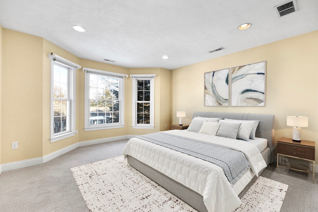 52 Chandler Circle Andover, MA 01810 - Photo 20 of 25 a spacious bedroom with a large bed and a window