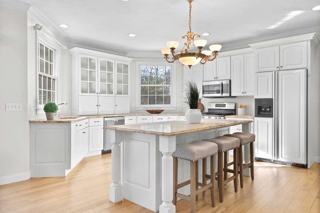 52 Chandler Circle Andover, MA 01810 - Photo 4 of 25 a kitchen with kitchen island granite countertop a center island a sink stainless steel appliances and cabinets