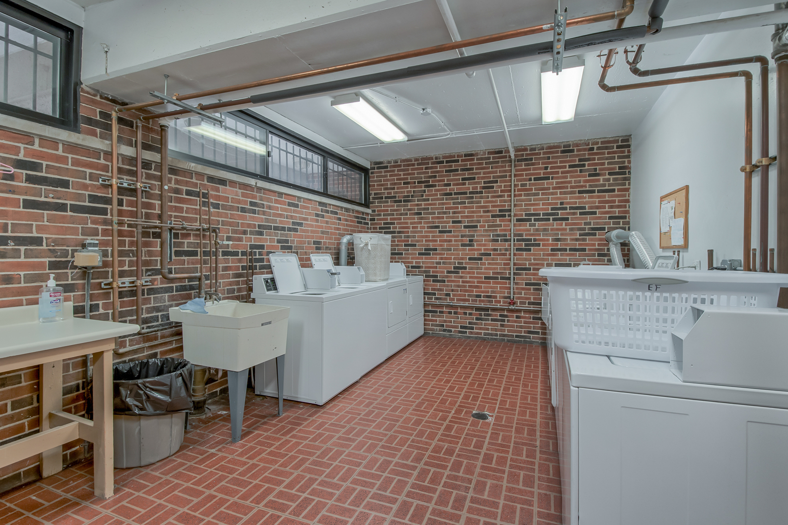2336 North Commonwealth Avenue, Unit 107 Chicago, IL 60614 - Photo 12 of 12 a bathroom with a sink a toilet and shower
