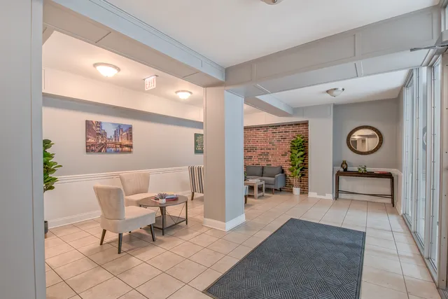 a living room with furniture and a clock