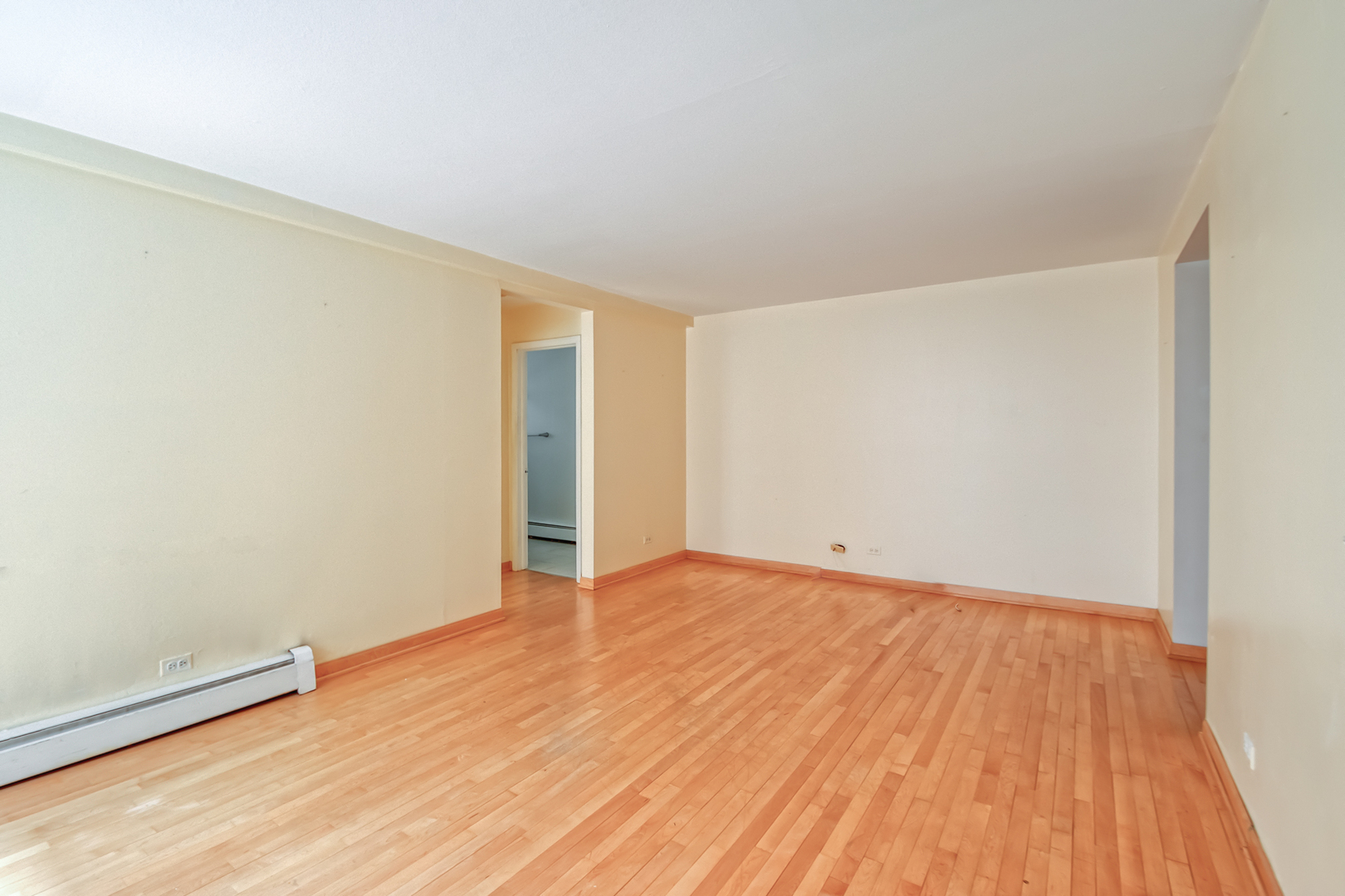 2336 North Commonwealth Avenue, Unit 107 Chicago, IL 60614 - Photo 4 of 12 a view of an empty room with wooden floor