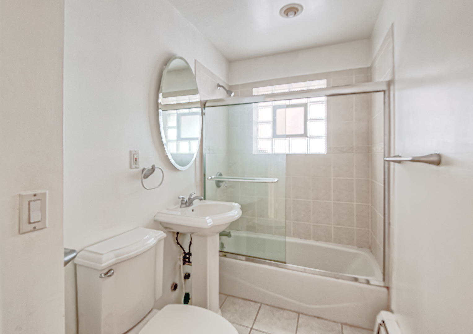 2336 North Commonwealth Avenue, Unit 107 Chicago, IL 60614 - Photo 10 of 12 a bathroom with a sink a toilet and a mirror