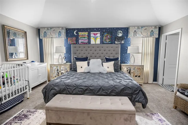 a bedroom with a large bed and a window