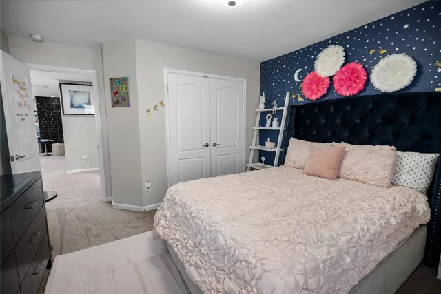 a bedroom with a bed and a chandelier