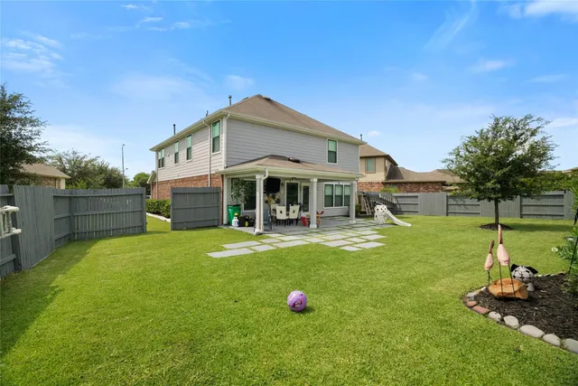 a front view of a house with a yard table and chairs