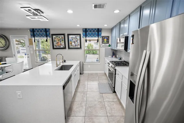 a kitchen with stainless steel appliances a refrigerator and a stove