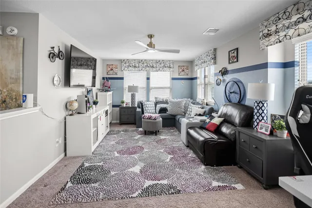a living room with furniture a rug and a chandelier