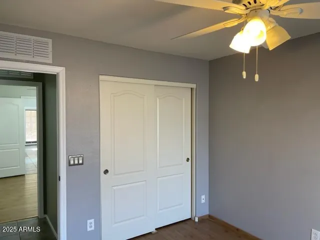 a view of a livingroom with a chandelier fan and a bathroom
