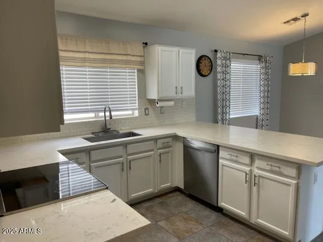 a kitchen with stainless steel appliances granite countertop a sink and a stove