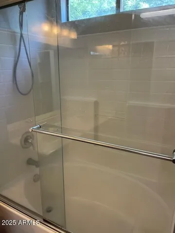 a bathroom with a glass shower door