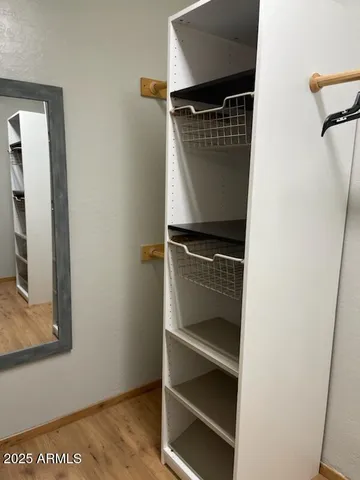 a view of walk in closet with empty racks