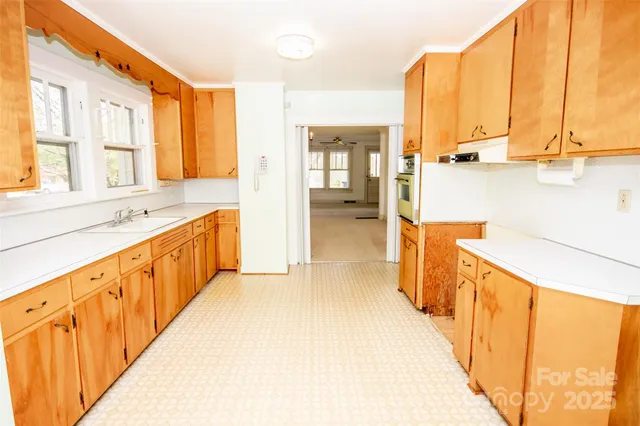 a view of a kitchen with a large window