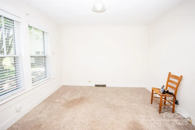 a view of a room with furniture and a window