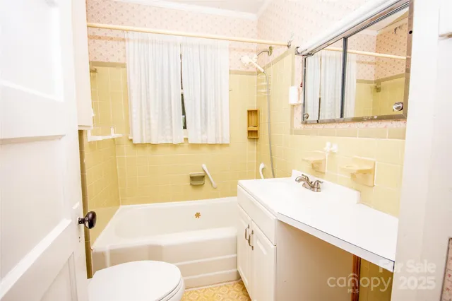 a bathroom with a sink a toilet and bathtub