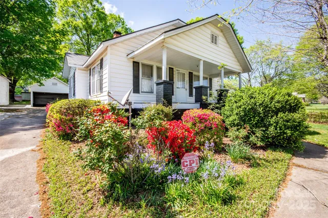 a front view of a house with a yard and fountain