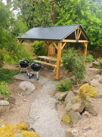 a patio with a table and chairs under an umbrella