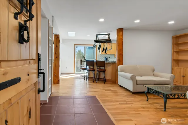 a kitchen with stainless steel appliances granite countertop a sink a stove and a wooden floors