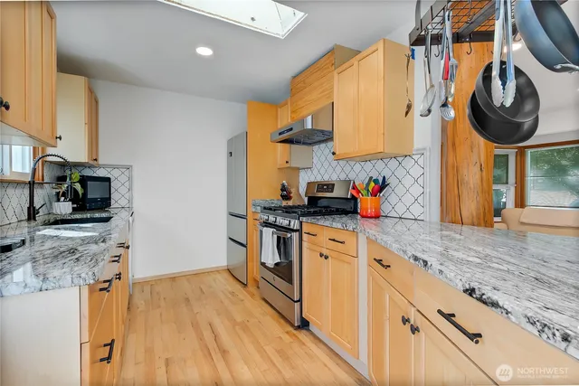 a view of an empty room with a fireplace and a window