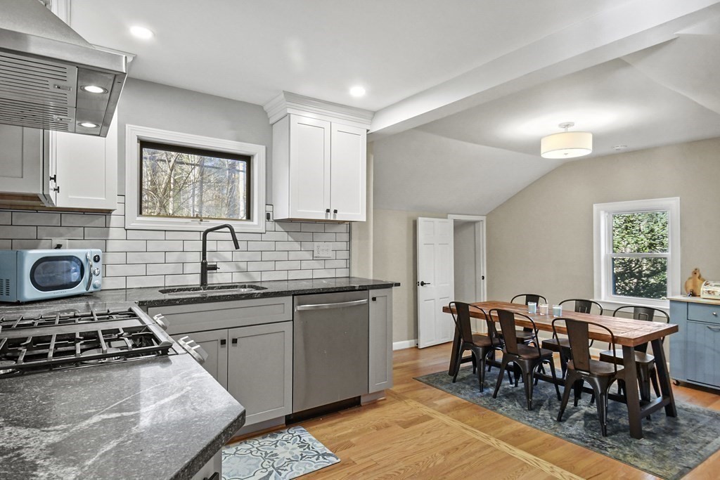 132 Pepperell Road Groton, MA 01450 - Photo 12 of 31 a kitchen with stainless steel appliances a sink a stove a table and chairs