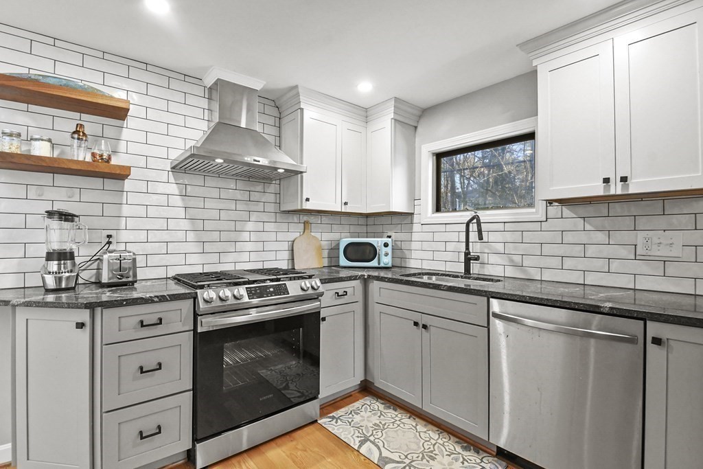 132 Pepperell Road Groton, MA 01450 - Photo 14 of 31 a kitchen with stainless steel appliances granite countertop a sink stove and cabinets