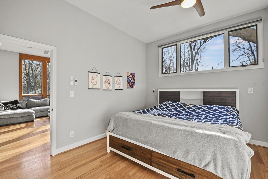 132 Pepperell Road Groton, MA 01450 - Photo 17 of 31 a bedroom with a bed and wooden floor
