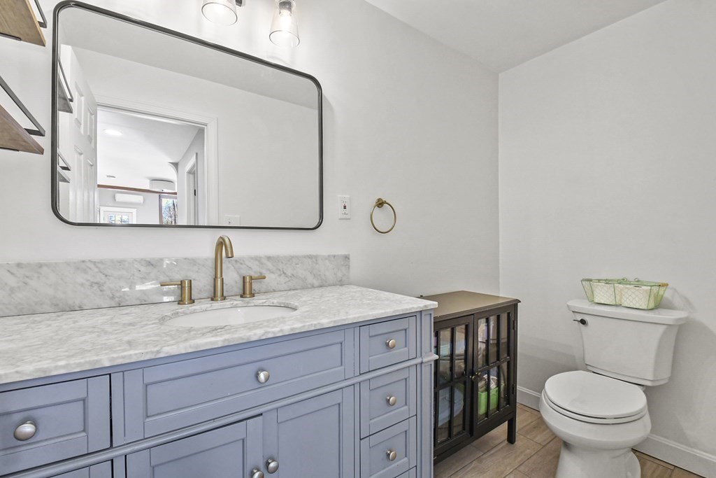 132 Pepperell Road Groton, MA 01450 - Photo 19 of 31 a bathroom with a granite countertop toilet sink and mirror