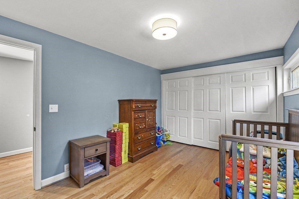 132 Pepperell Road Groton, MA 01450 - Photo 21 of 31 a bedroom with furniture and a book shelf