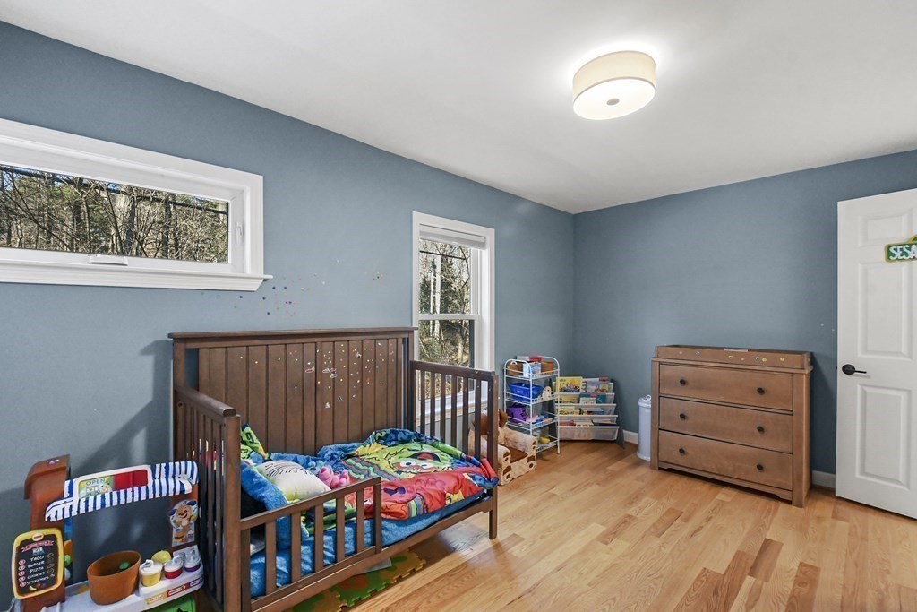 132 Pepperell Road Groton, MA 01450 - Photo 22 of 31 a bedroom with furniture and a wooden floor