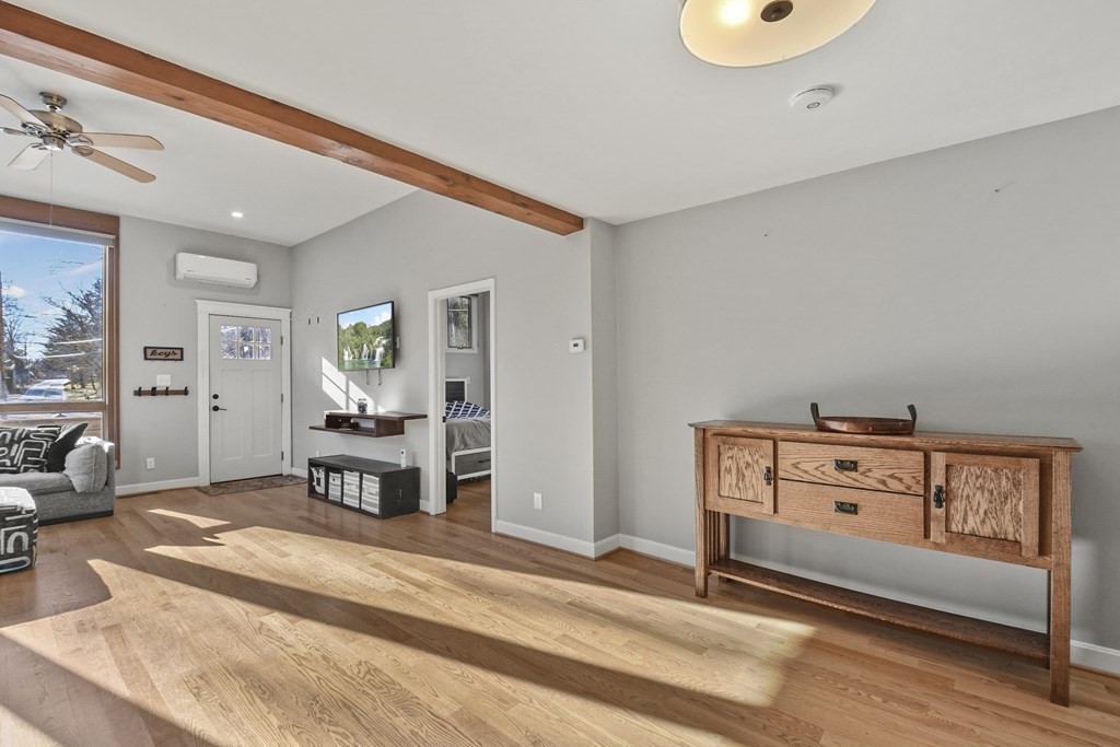 132 Pepperell Road Groton, MA 01450 - Photo 9 of 31 a bedroom with furniture and a wooden floor