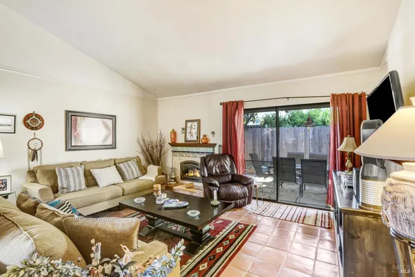 a living room with furniture and a floor to ceiling window