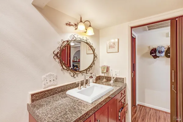 a bathroom with a sink vanity and a mirror