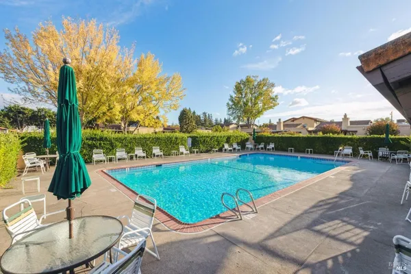 a view of a swimming pool with a lounge chairs