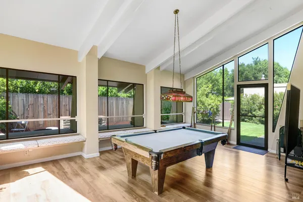 a living room with furniture a table and a floor to ceiling window