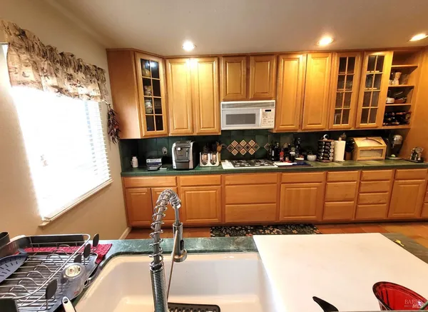 a kitchen with sink a window and cabinets