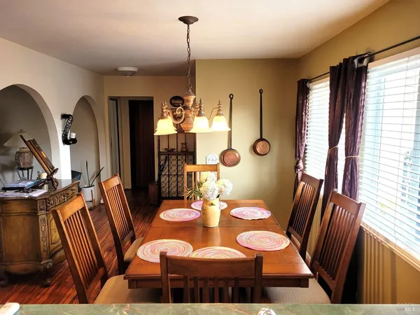a view of a dining room with furniture window and wooden floor