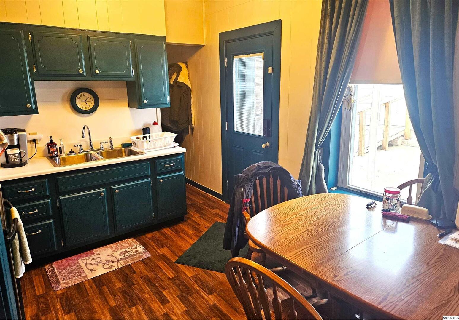 933 Adams Street Quincy, IL 62301 - Photo 11 of 26 a bedroom with a bed and a table