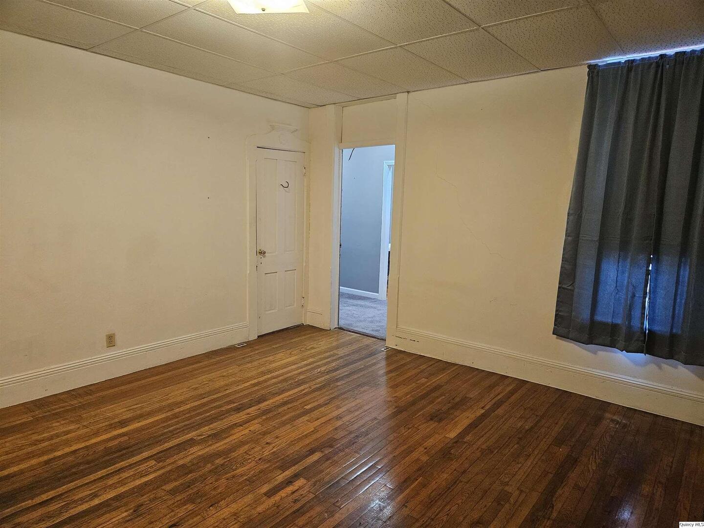 933 Adams Street Quincy, IL 62301 - Photo 16 of 26 a view of an empty room with wooden floor