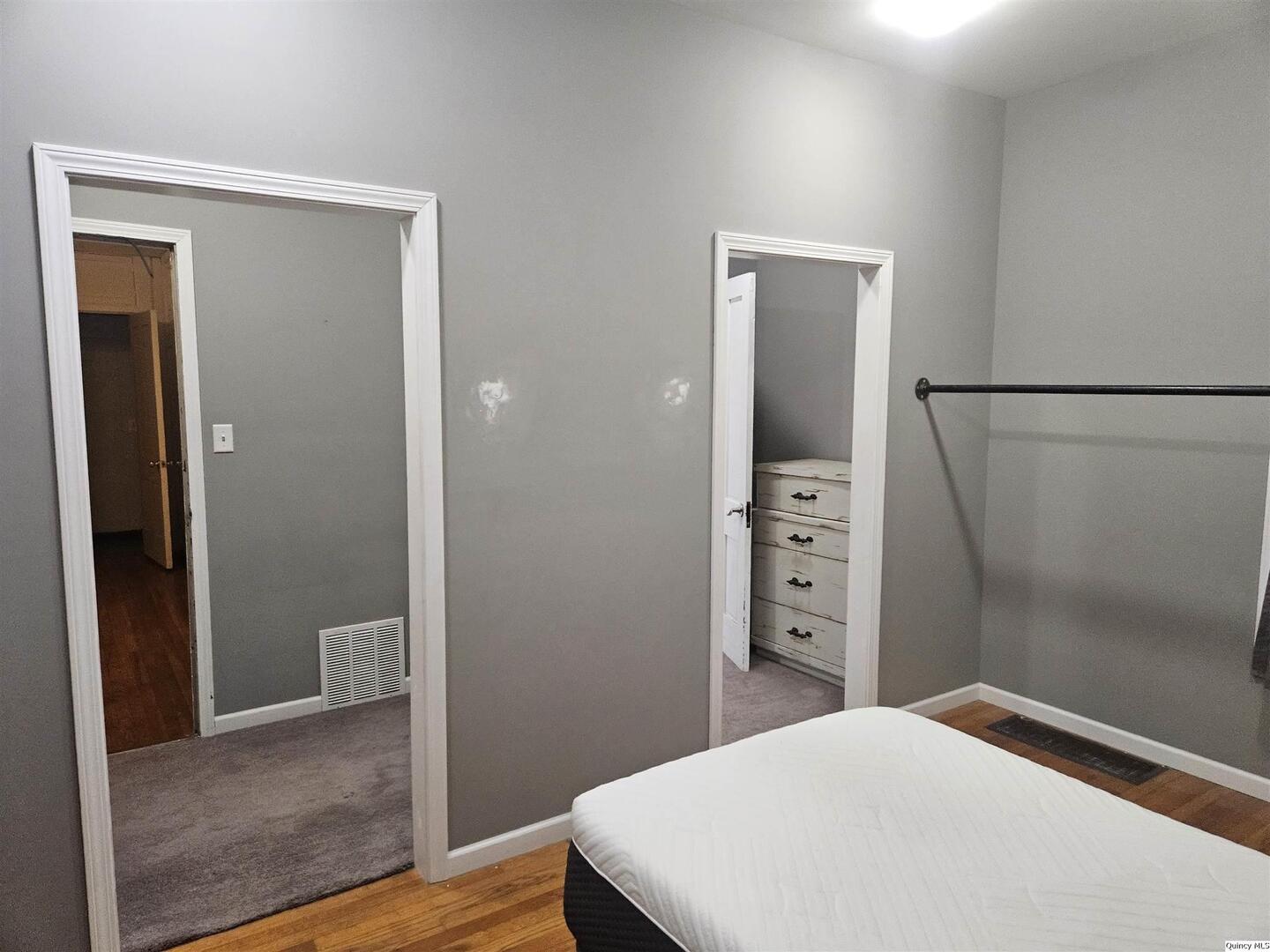 933 Adams Street Quincy, IL 62301 - Photo 18 of 26 a bedroom with a bed and a view of bathroom