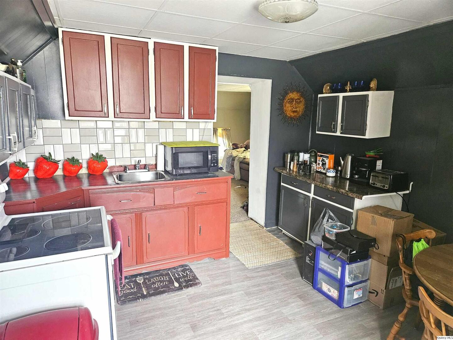 933 Adams Street Quincy, IL 62301 - Photo 20 of 26 a kitchen with stainless steel appliances granite countertop a sink stove and cabinets