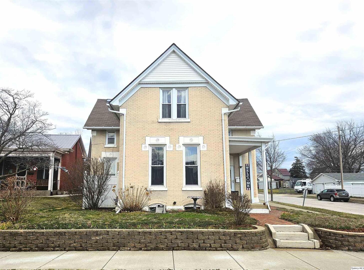 933 Adams Street Quincy, IL 62301 - Photo 2 of 26 a front view of a house with a yard