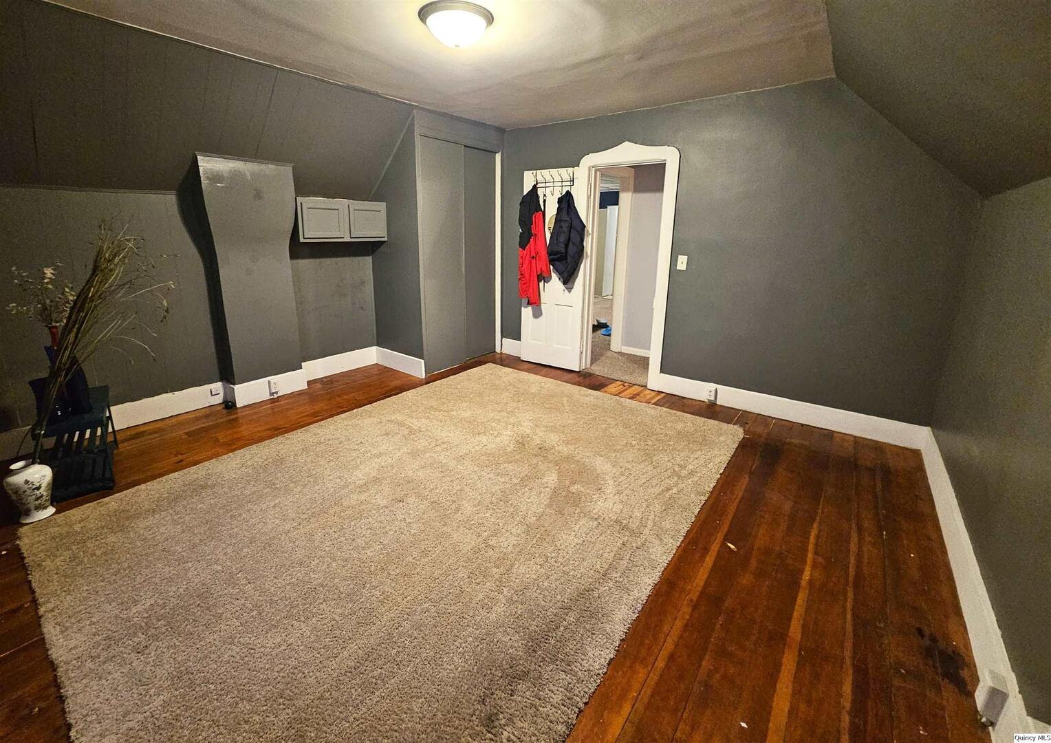 933 Adams Street Quincy, IL 62301 - Photo 23 of 26 a bed sitting in a bedroom next to a window