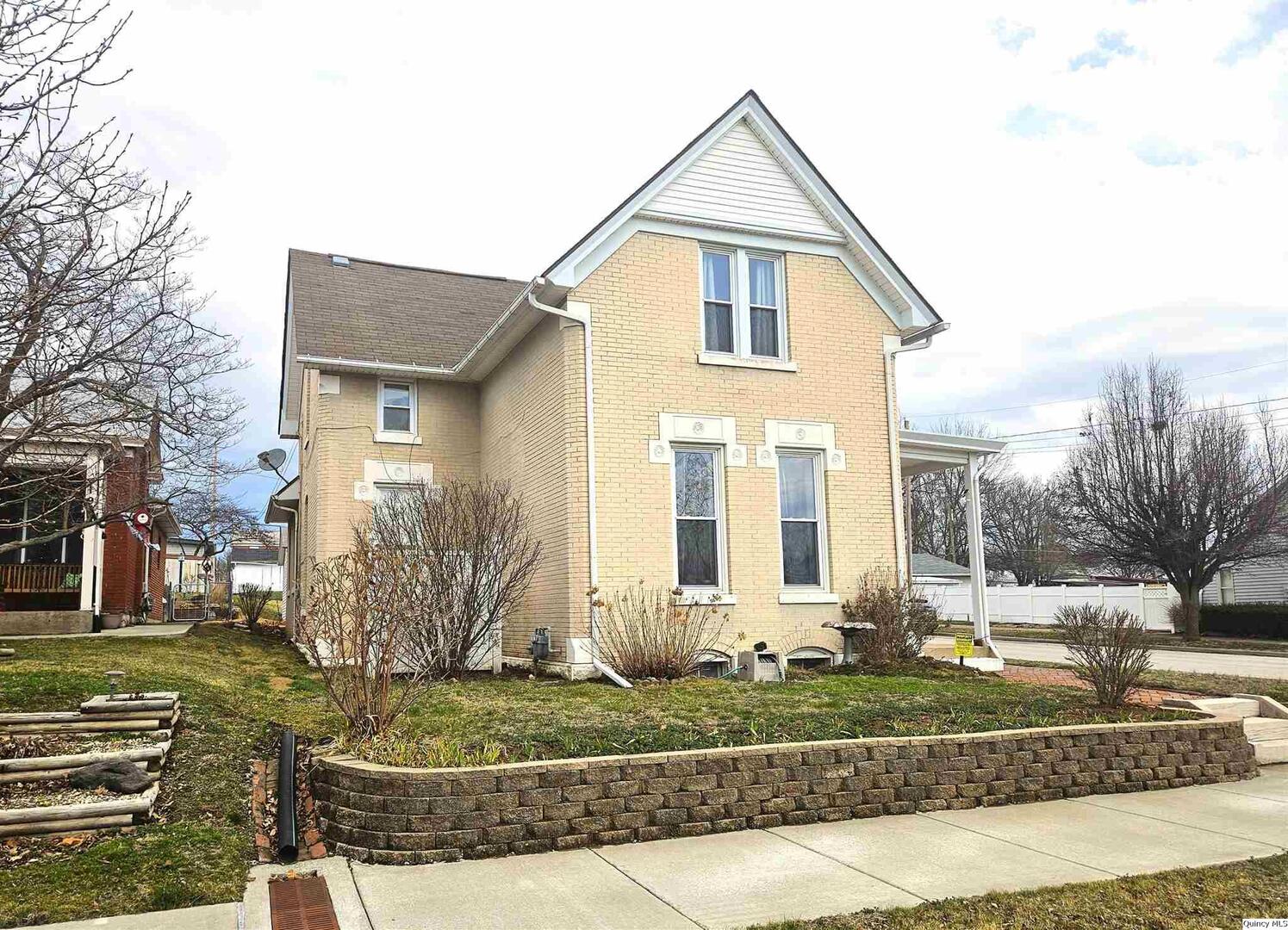 933 Adams Street Quincy, IL 62301 - Photo 3 of 26 a front view of a house with a yard