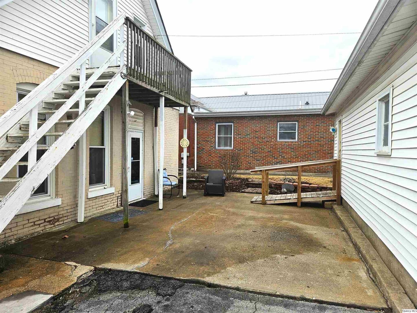 933 Adams Street Quincy, IL 62301 - Photo 6 of 26 a view of a house with a barbeque and wooden stairs