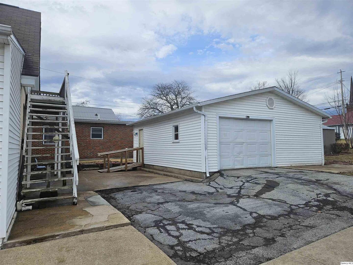 933 Adams Street Quincy, IL 62301 - Photo 7 of 26 a view of a house with a backyard